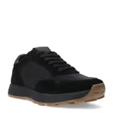 Zapatillas deportivas negras con detalles en gamuza y suela marrón.