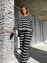Conjunto de buzo y pantalón a rayas horizontales blancas y negras. El buzo es de corte amplio y el pantalón es recto.