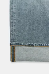 Jeans de mujer tiro medio, corte ancho (baggy) y pierna recta, con efecto lavado azul claro. Presenta cinco bolsillos y bajo acabado con vuelta ancha.