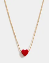 Collar dorado con dije de corazón rojo.