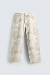 Pantalón de jean blanco, corte holgado y amplio en toda la pierna, tiro medio, tejido ligero, cinco bolsillos, efecto lavado y cierre frontal con cremallera y botón.