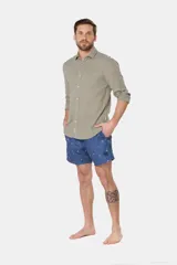 Short de baño clásico azul con estampado de palmeras, con cintura elástica y cordón regulable, dos bolsillos laterales y suspensor de malla fina.