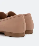 Zapato loafer flat color nude con tachas y taco bajo.