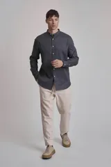 Camisa de lino azul con cuello mao y mangas largas.