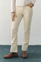 Jean recto color arena, con diseño clásico de cinco bolsillos.