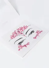 Adhesivos de strass en tonos morados diseñados para decorar el rostro.