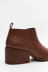 Botín negro de cuero sintético con punta fina y taco ancho de 6cm.