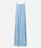 Vestido largo celeste de jeans con breteles finos, escote cuadrado, lazo en la espalda y abertura en la parte inferior.