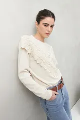 Sweater color crema de punto liso con detalle de crochet en el escote y en forma de pico sobre el pecho.