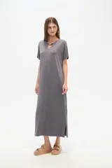 Vestido midi negro de poliéster, corte holgado, manga corta, cuello en V y detalle de cuentas en el escote.