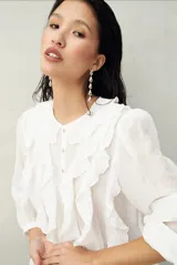 Camisa negra de tencel liviana con volados románticos y manga corta.