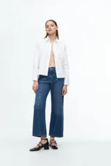 Pantalón de jean de cintura alta con piernas anchas, sutilmente descolorido para un aspecto desgastado.