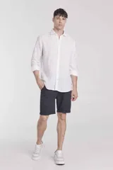Camisa blanca de corte slim fit con cuello clásico, manga larga y estampado de puntos.