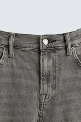 Pantalón de jean negro, corte slim fit, con tiro medio, cinco bolsillos, efecto lavado y cierre frontal con cremallera y botón.