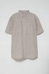Camisa de manga corta con estampado a cuadros en tonos grises y blancos.