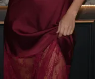 Vestido midi de seda color borgoña con breteles finos y encaje en el escote y el ruedo.