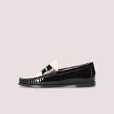 Mocasín bicolor de charol negro con pala de piel blanca, detalle de antifaz clásico, plantilla interior de piel acolchada y suela fina antideslizante.