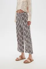 Pantalón recto de poliéster con estampado a rayas verticales en blanco y negro.