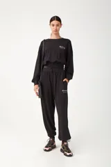 Pantalón de jogging negro de algodón, con cintura y tobillos elastizados, cordón de ajuste y bolsillos frontales con logo estampado.