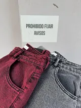 Pantalón de jean color borgoña, de corte extra wide, tiro alto y cinco bolsillos.