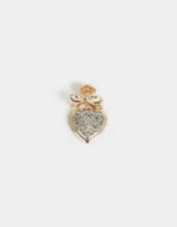Pin dorado con forma de corazón calado plateado y moño dorado.
