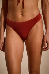 Bombacha de bikini tipo vedetina color bordó con textura arrugada.