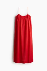 Vestido midi rojo de breteles finos y corte evasé, confeccionado en tejido de mezcla de algodón con efecto arrugado.