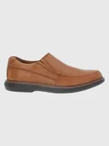 Zapato de vestir color marrón, sin cordones, de cuero vacuno liso. Tiene elásticos laterales, plantilla de cuero y algodón orgánico, y suela de goma EVA.