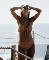 Conjunto de bikini color ocre, con corpiño tipo top con nudo central y bombacha vedetina de tiro alto.