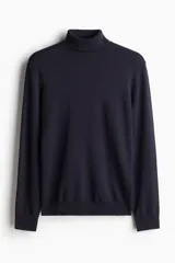 Polera azul marino de punto fino suave, con cuello alto, puños y bajo acanalados. Corte ajustado.