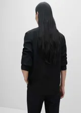 Camisa negra de seda de mora con cuello camisero, corte recto, mangas largas con puños abotonados y cierre frontal con botones.