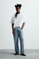 Pantalón de jean celeste de corte amplio, con efecto lavado y roturas.