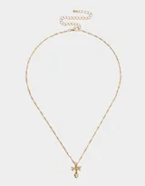 Cadena corta dorada con dije de moño con piedras de zirconia y dije de corazón colgante.