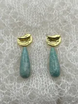 Par de aros colgantes con base dorada y dije de amatista en forma de lágrima.