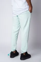 Pantalón de jogging negro de corte oversize, con puños elásticos y estampado con la palabra 'FUTURO' en verde y amarillo.