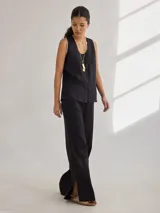 Pantalón de lino color ladrillo, de corte recto con tajos laterales en el ruedo y cintura elastizada.