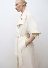 Abrigo color blanco hueso con cuello solapa grande y doble botonadura.