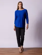Buzo azul tejido en hilado fino, marca Cable & Gauge. Escote redondo con calados. Manga ¾, modelo dolman. Mangas con aplique de botones.