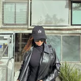 Gorro de béisbol negro con logo bordado en blanco en el frente y en el lateral.