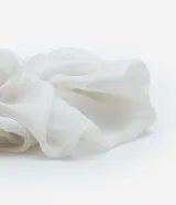 Coletero scrunchie blanco de tela traslúcida con textura.
