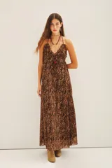 Vestido largo de gasa con lurex y estampado reptil en tonos marrones. Tiene escote en V con volados y breteles finos.