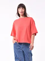 Remera color coral de corte holgado y mangas cortas.