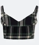 Top corto de tricolina con estampado de cuadros en tonos negro, verde y blanco. Tiene tirantes finos ajustables y elástico en la espalda.