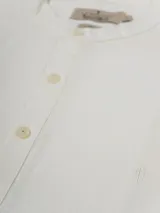 Camisa de manga larga color crudo, confeccionada en lino. Presenta cuello mao y cierre frontal con botones. Marca La Dolphina.