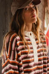 Sweater oversize de punto con cuello polo y cartera con botones, con diseño a rayas horizontales en tonos marrón, celeste y naranja.