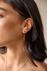 Aros colgantes de acero quirúrgico hipoalergénico con dije de piedra natural en forma de gota color azul oscuro.