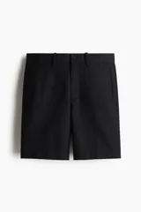 Bermuda negra de sarga suave en mezcla de algodón y lyocell. Modelo con pliegues adelante, cierre con botón, bolsillos laterales ribeteados y bolsillos insertados atrás con botón. Corte estándar para una silueta clásica y cómoda.