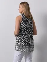 Blusa sin mangas con estampado animal print en blanco y negro, escote en V y tajo en costuras laterales.