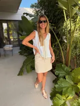 Musculosa tejida en látex metálico, con escote en V tanto en el frente como en la espalda, y detalle deshilachado en el frente.