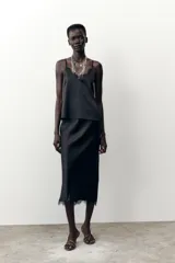 Falda midi negra de satén con cintura elástica y detalle de encaje en el ruedo.